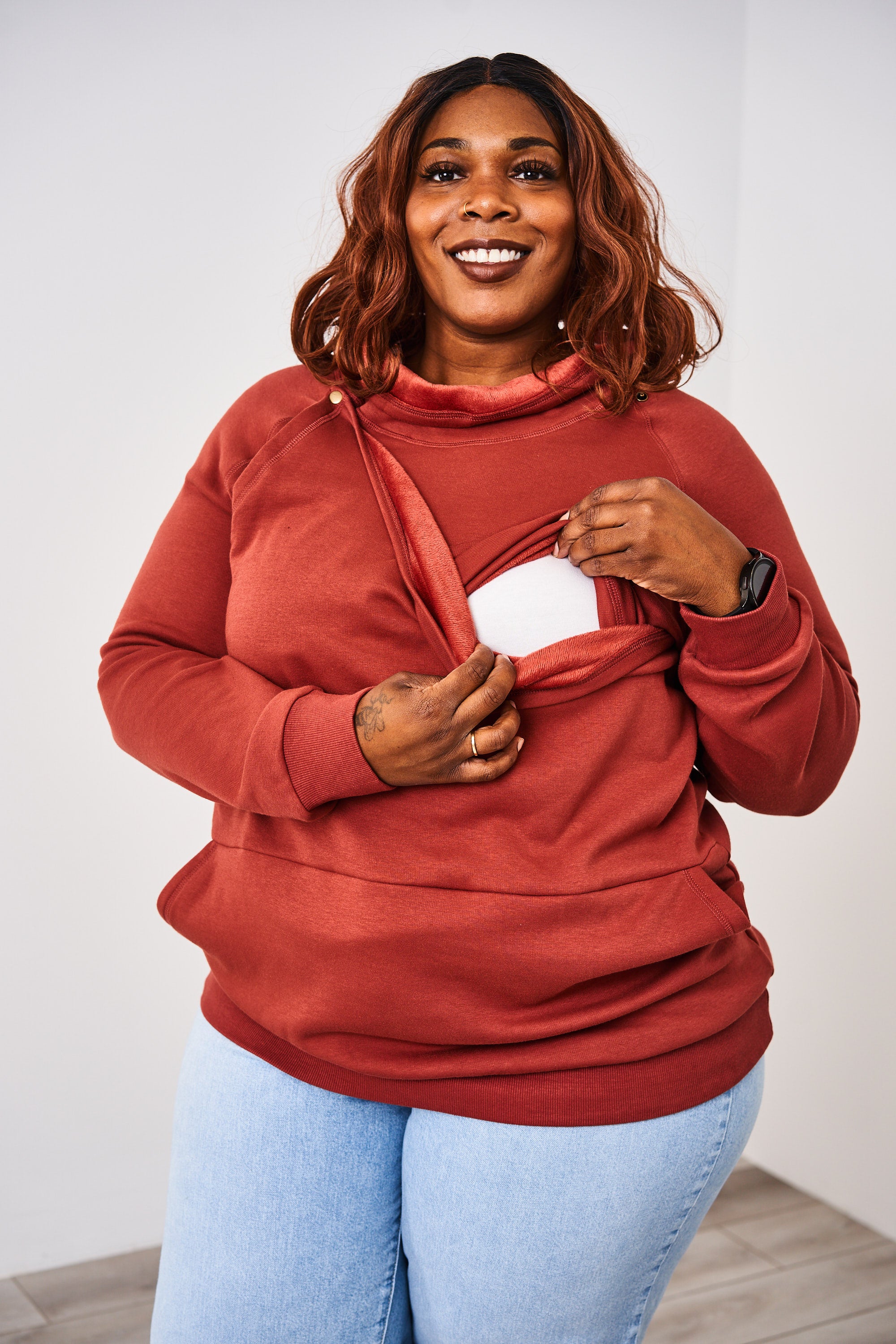 Woman showing the snap down nursing access of the Latched Mama Harbor Snap Nursing Pullover