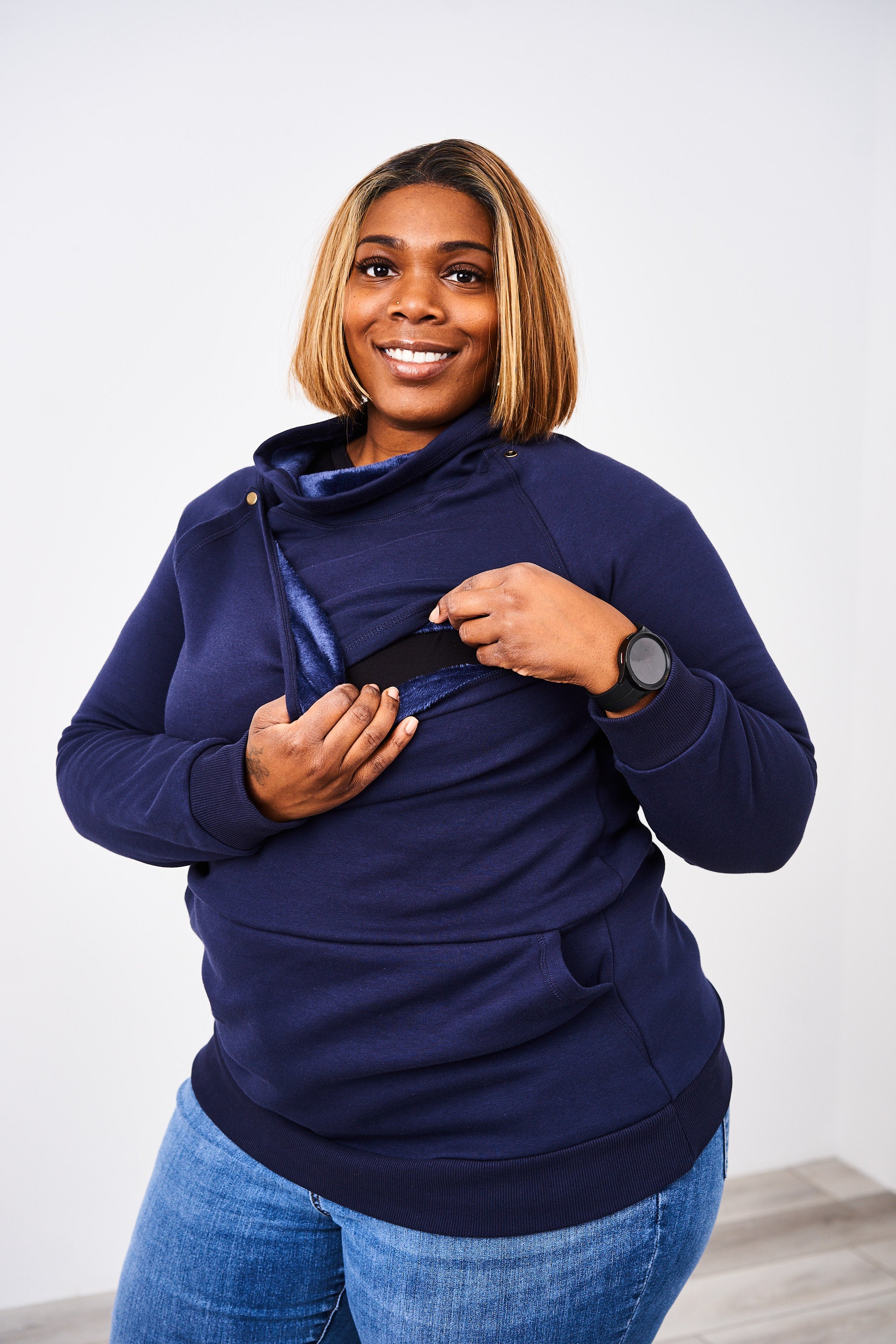 Woman opening the front snaps on the Latched Mama Harbor Snap Nursing Pullover for hands free nursing