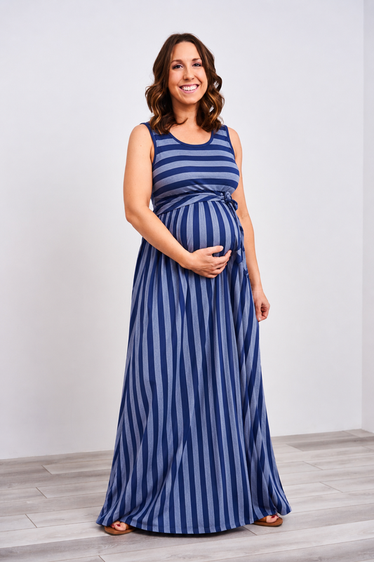Pregnant woman wearing a latched mama boardwalk nursing maxi dress in blue stripes.