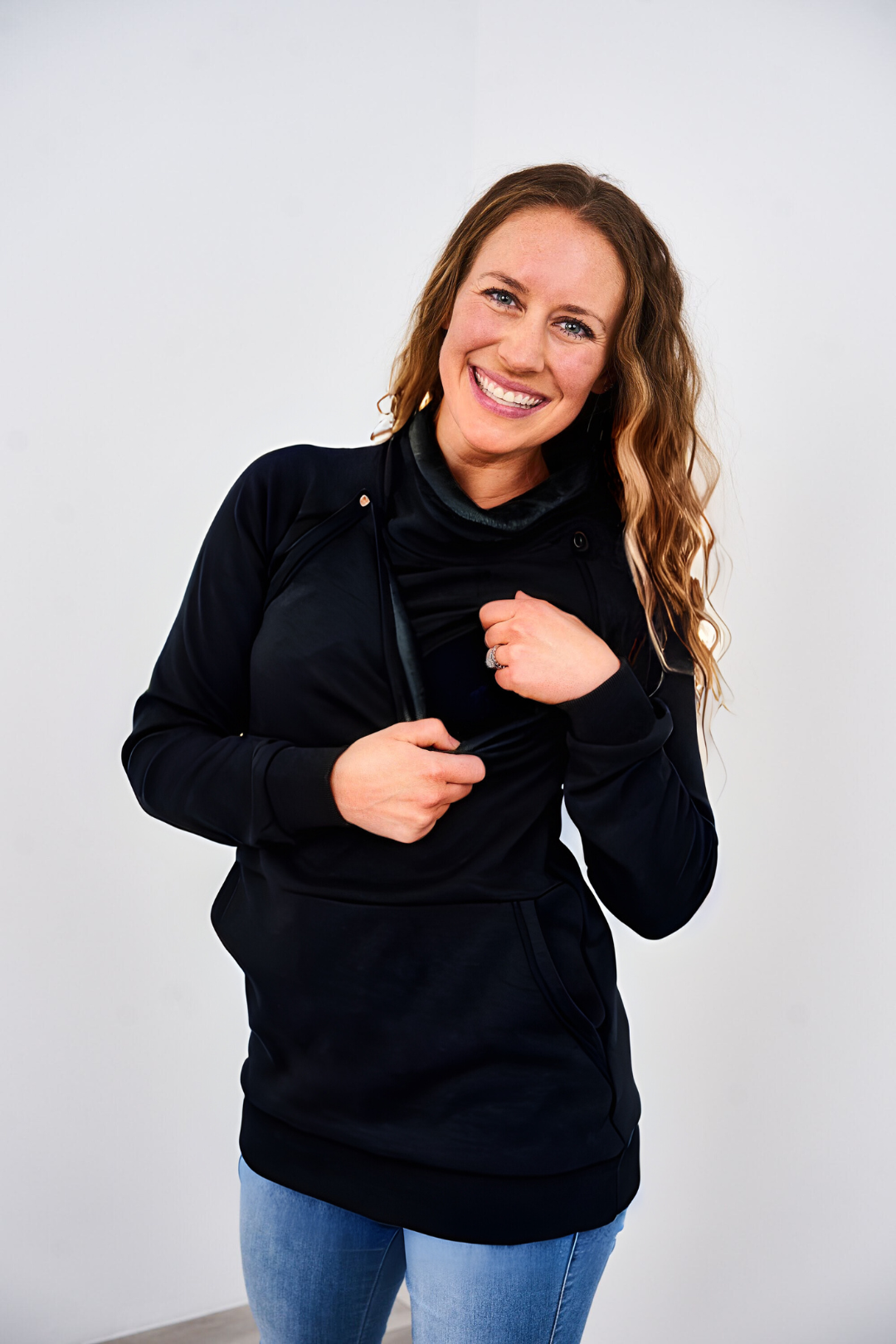 Mom showing how the snap-down nursing access works on the Latched Mama Harbor Snap Nursing Pullover