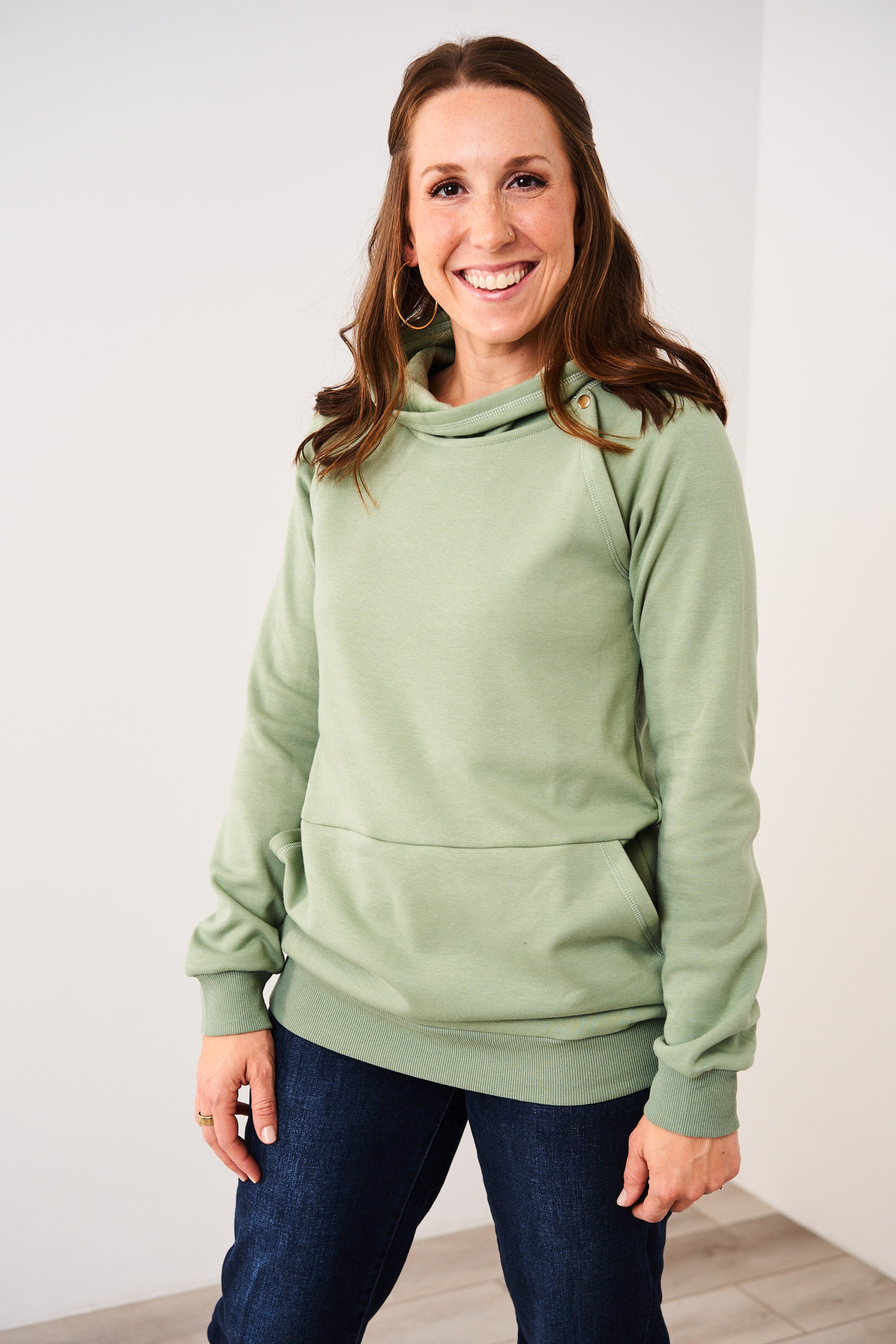 Woman wearing a Latched Mama basil Harbor Snap Nursing Pullover