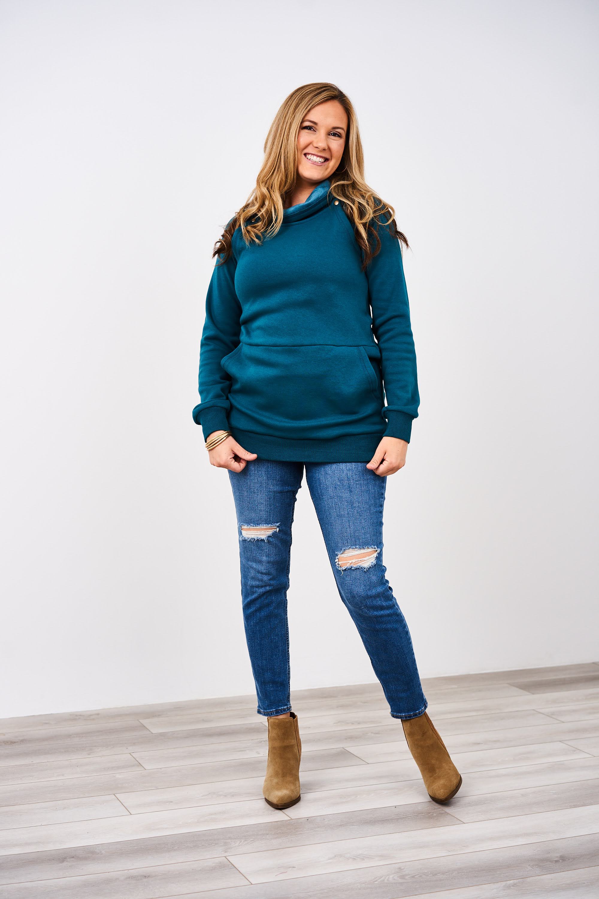 A woman wearing a Peacock Latched Mama Harbor Snap Nursing Pullover