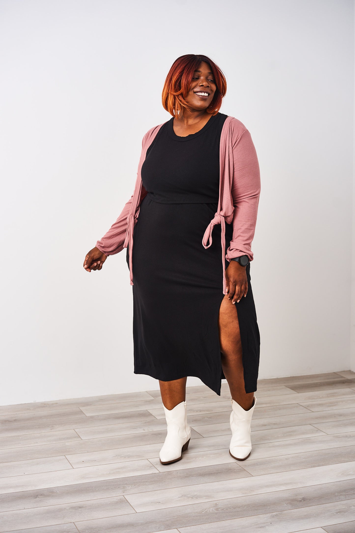 Woman wearing a Latched Mama nursing black ribbed nursing slit dress.