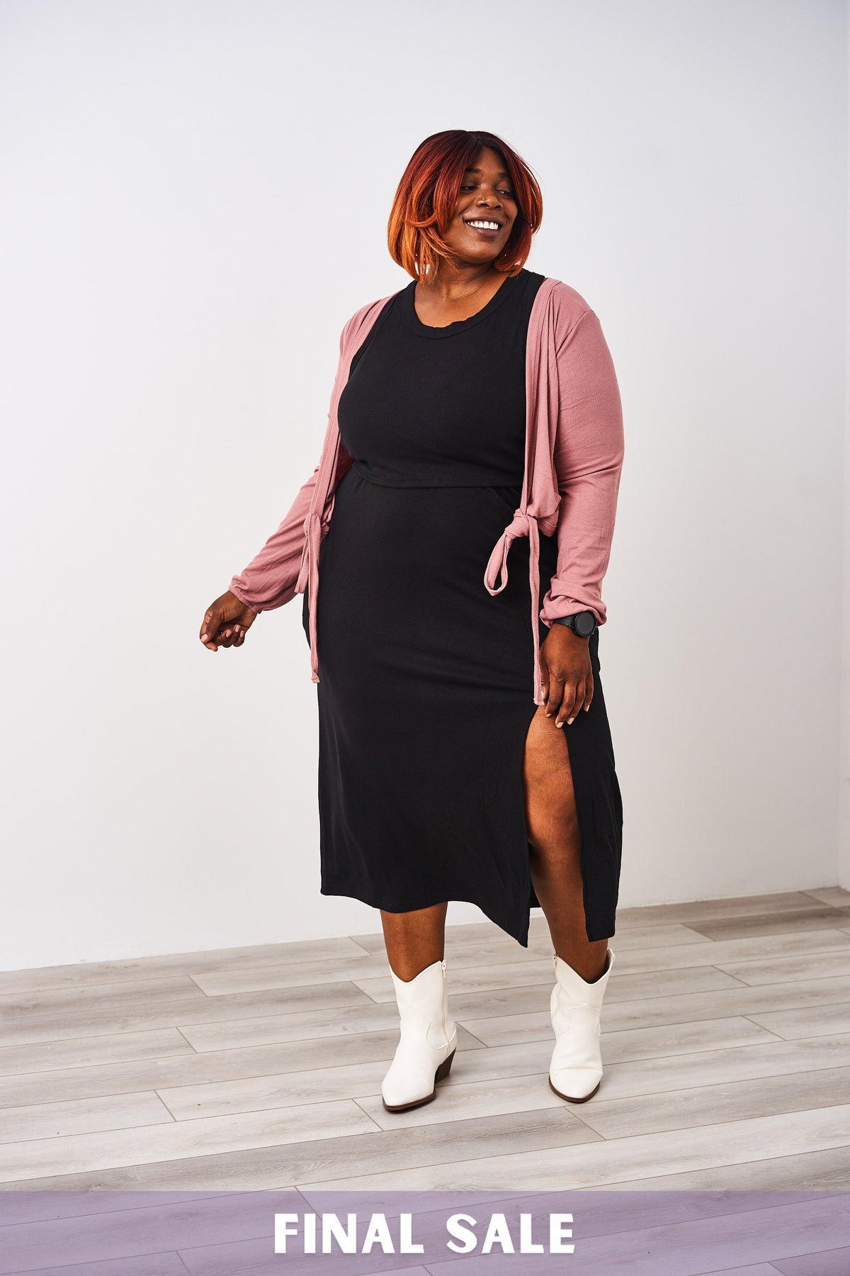 Woman wearing a Latched Mama nursing black ribbed nursing slit dress.