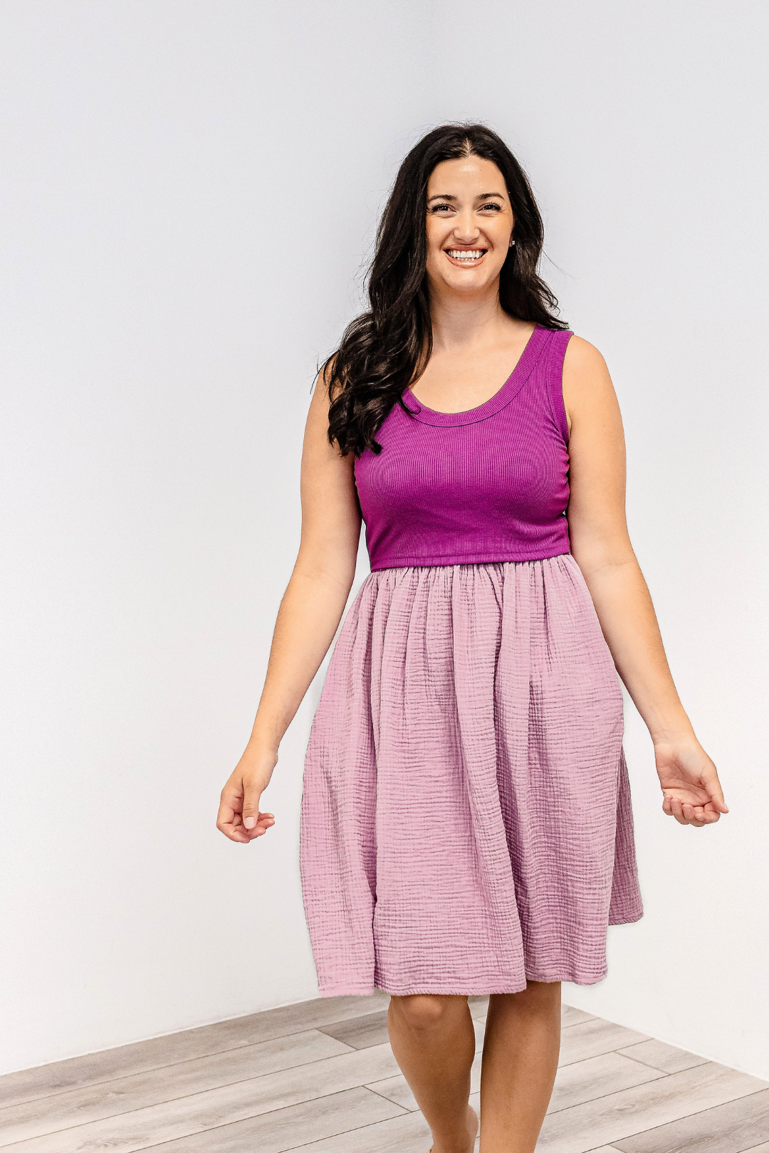 Woman smiling wearing the Latched Mama Breezy Cotton Nursing Dress in Pink/Purple.