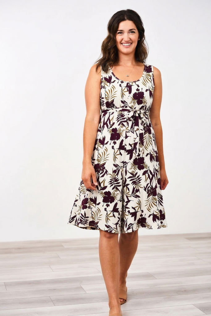 Woman wearing the Latched Mama Momper floral nursing romper on a white background