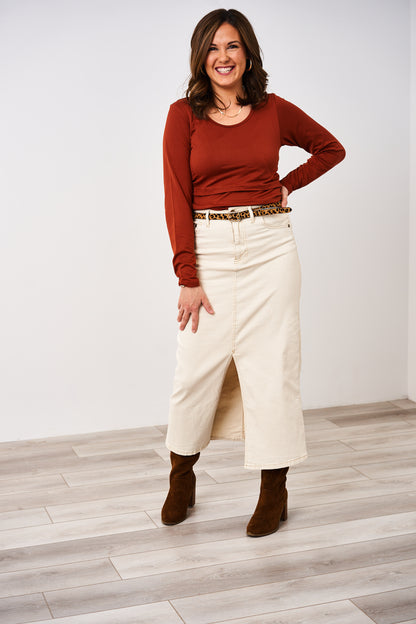 Woman wearing a rust Latched Mama nursing shirt with long skirt