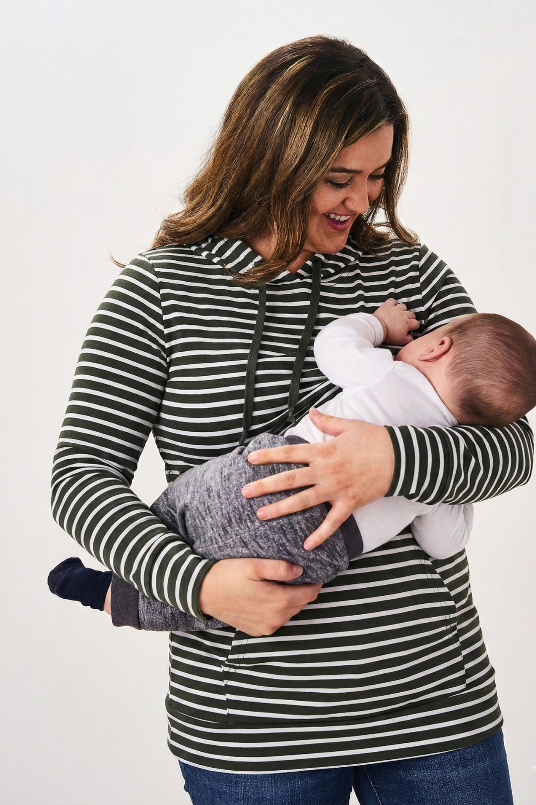 Woman nursing an infant while wearing the Latched Mama Lightweight Cotton Nursing Hoodie