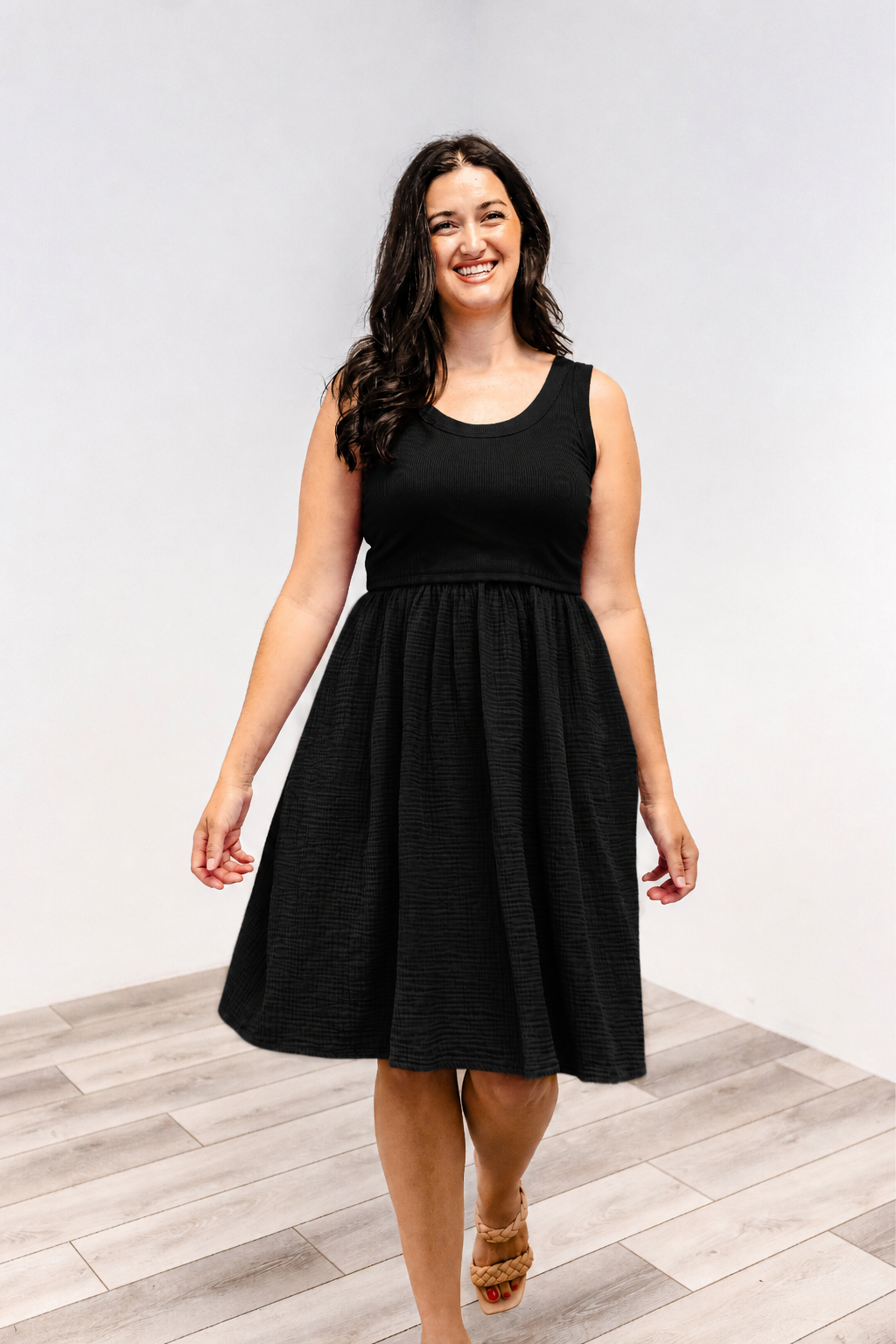 Woman wearing a Latched Mama Breezy cotton nursing dress in black.