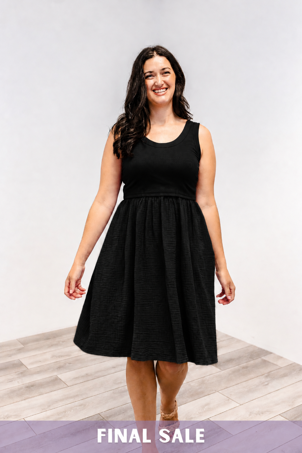 Woman wearing a Latched Mama Breezy cotton nursing dress in black.