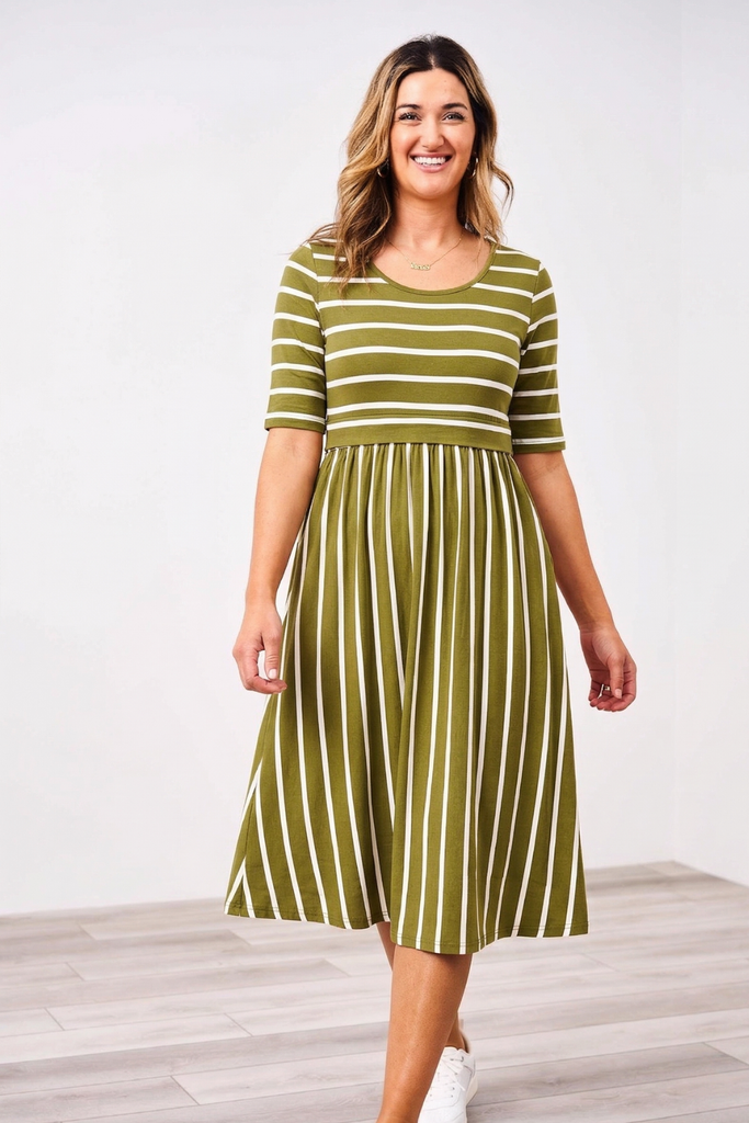 Woman wearing a green and white striped Latched Mama Nursing dress on a white background