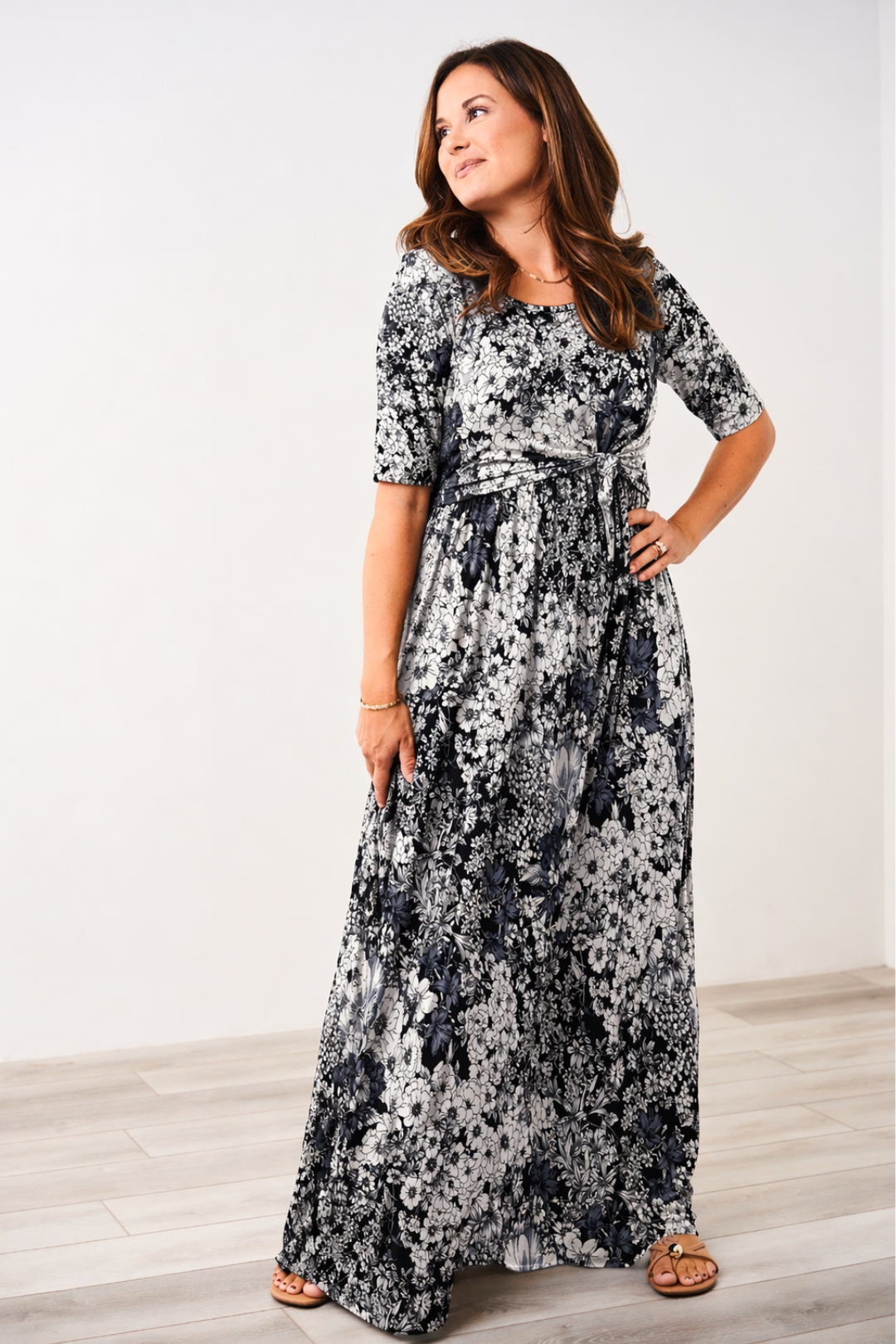 Woman wearing a Latched Mama front knot nursing maxi dress in black and white florals.