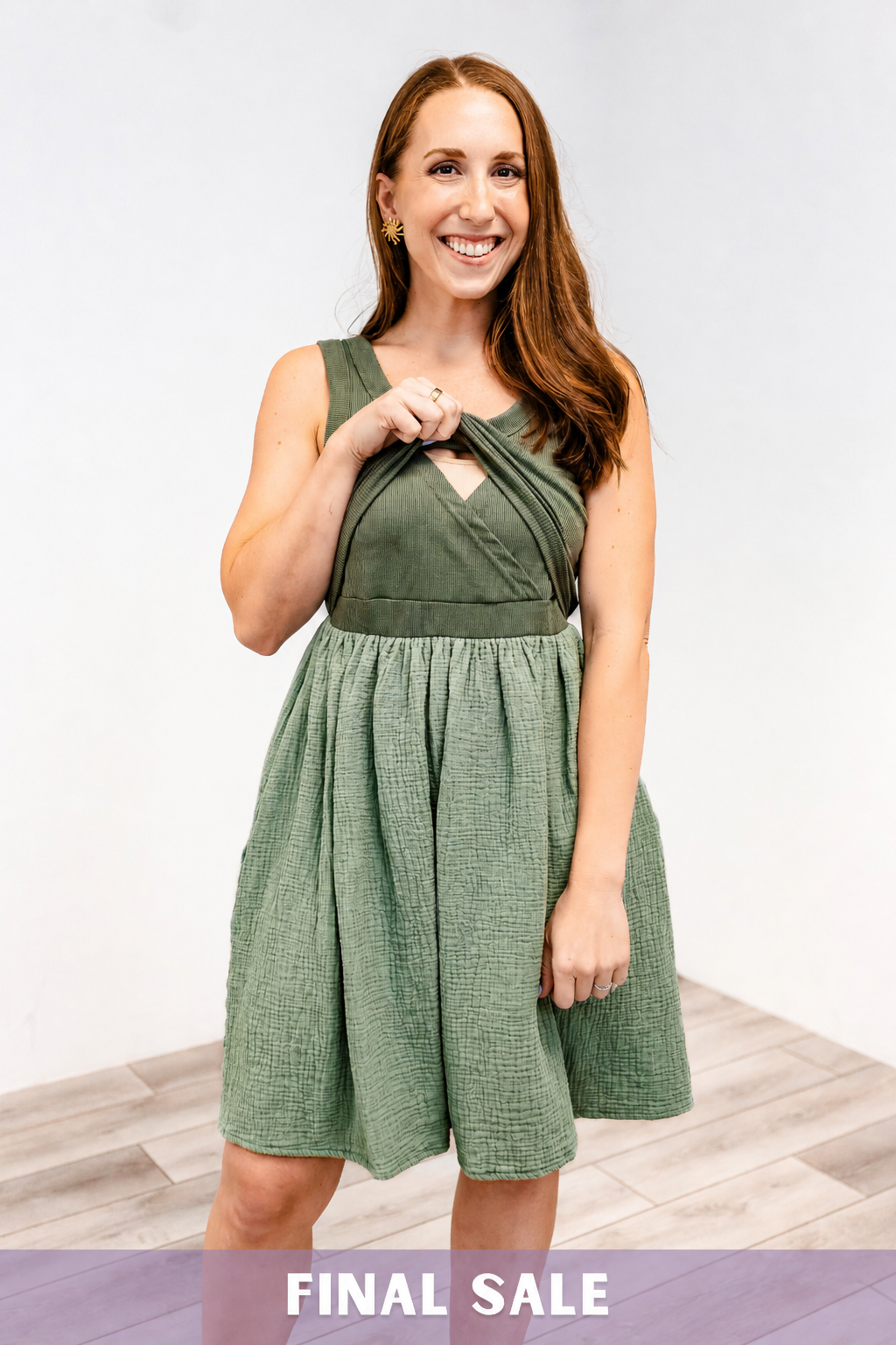 Woman showing the lift-up v-neck nursing access on the Latched Mama Breezy Cotton nursing dress in green.