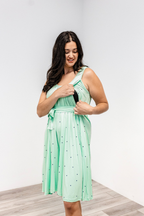 Woman showing the side nursing access on the Latched Mama nursing romper momper.