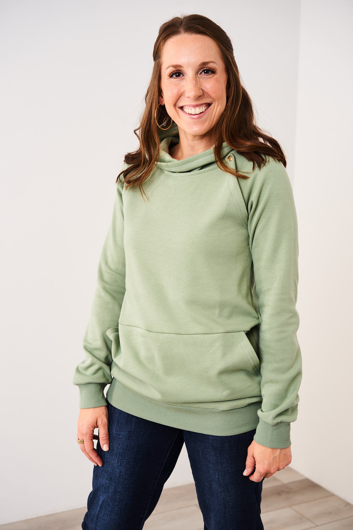 Woman wearing a Latched Mama basil Harbor Snap Nursing Pullover