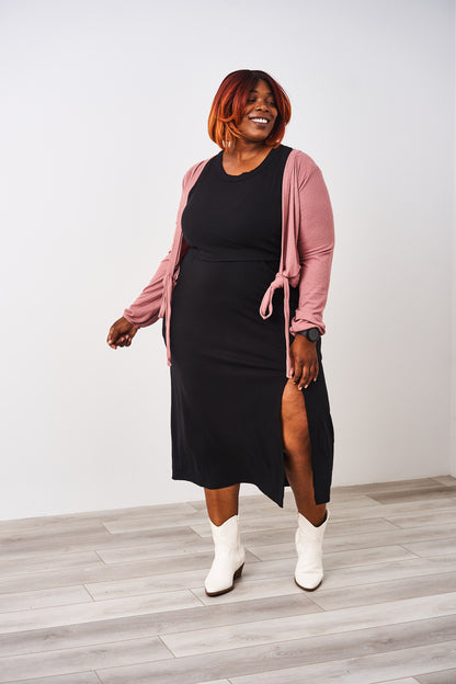Woman wearing a Latched Mama nursing black ribbed nursing slit dress.