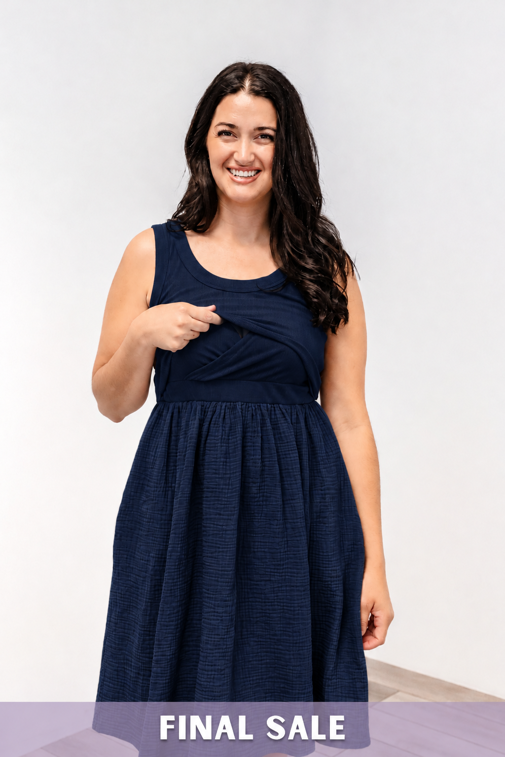 A woman showing the lift-up v-neck front nursing access on the Latched Mama Breezy Nursing Dress.