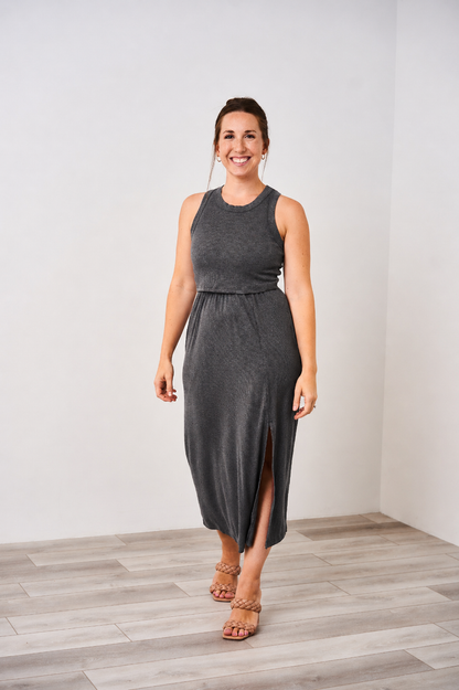 Woman wearing a Latched Mama dark charcoal nursing midi slit dress on a white background.
