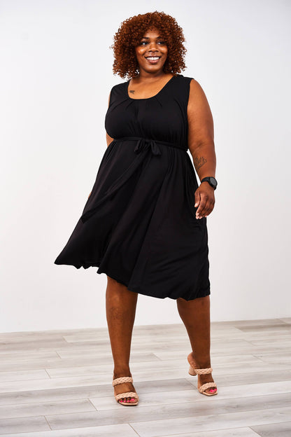 woman wearing a black latched mama nursing romper momper with beige heels