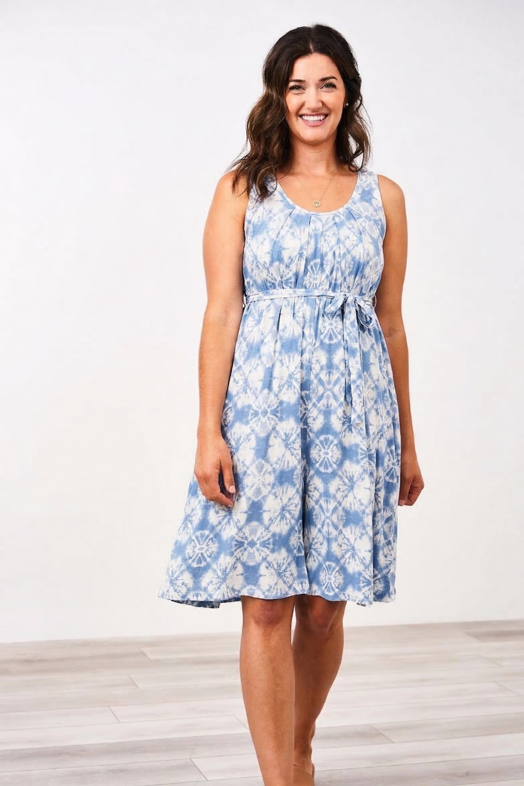Woman wearing a Latched Mama Nursing Romper in bluebell baltik on a white background