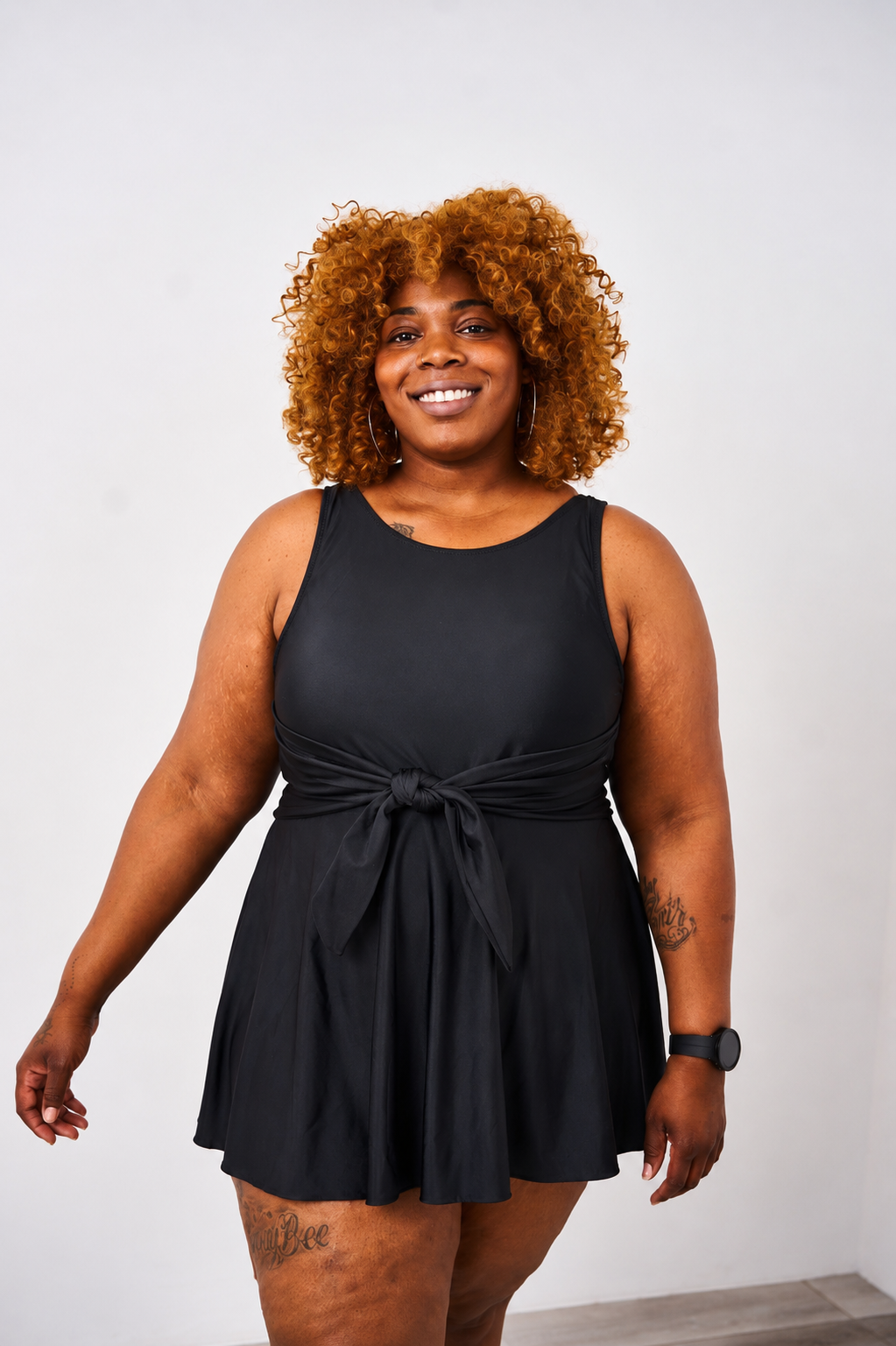 Woman wearing the latched mama nursing swim dress on a white background.