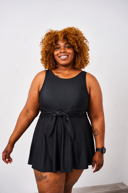 Woman wearing the latched mama nursing swim dress on a white background.