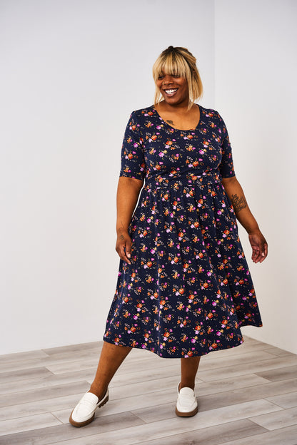 Woman wearing a navy floral Latched Mama nursing Classic Cotton dress 