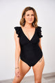 A woman wearing a Latched Mama lace-up nursing swim one-piece with ruffles on the shoulders and a v-neck design. T