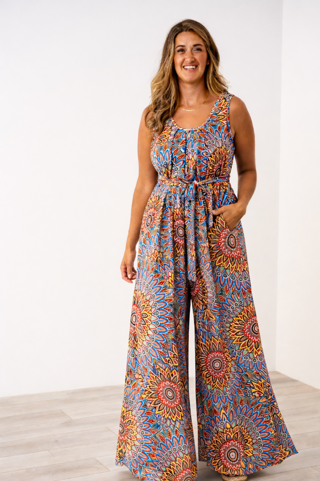 Woman wearing a Latched Mama nursing sleeveless momper in sol flower.