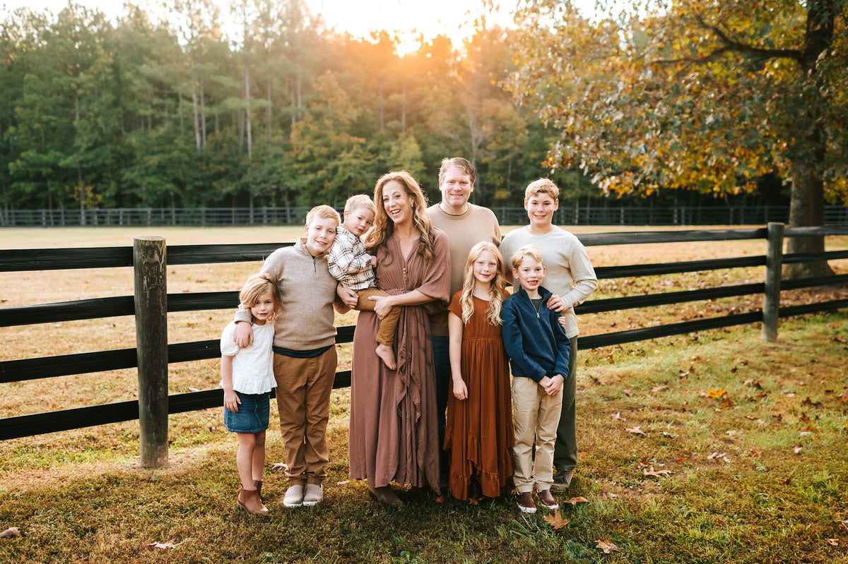 The Wirt family together beside the pasture fence in autumn 2024