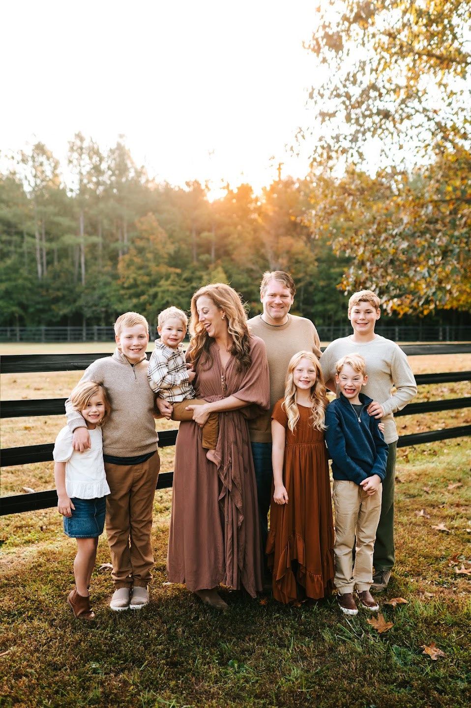 Melissa and Eric with their six children on the farm in 2024