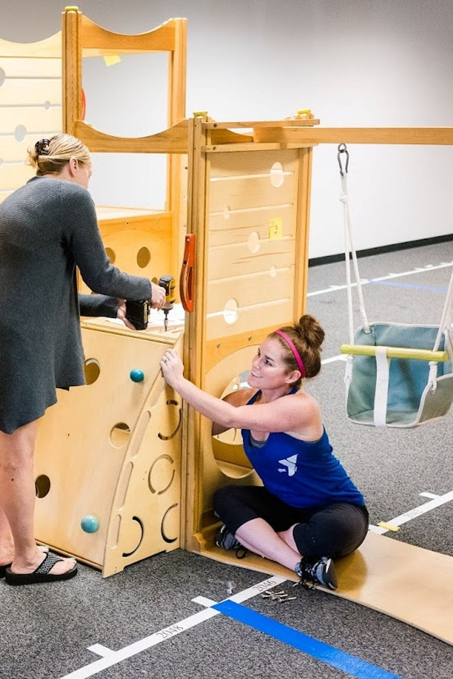 Latched Mama team members building an indoor play structure at the former office