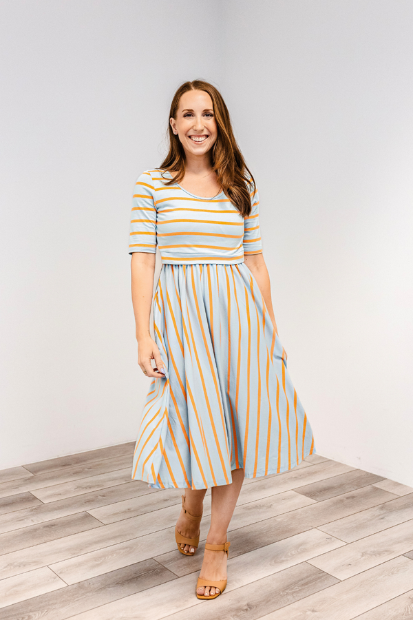 Woman wearing a saltwater stripes classic cotton nursing dress by latched mama.